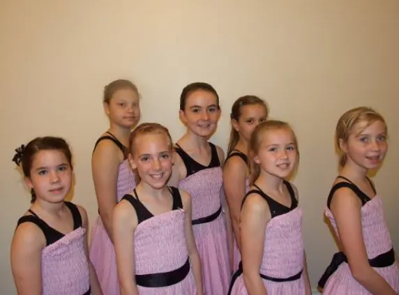 Junior pupils in pink and black costumes at a Harlow dance show